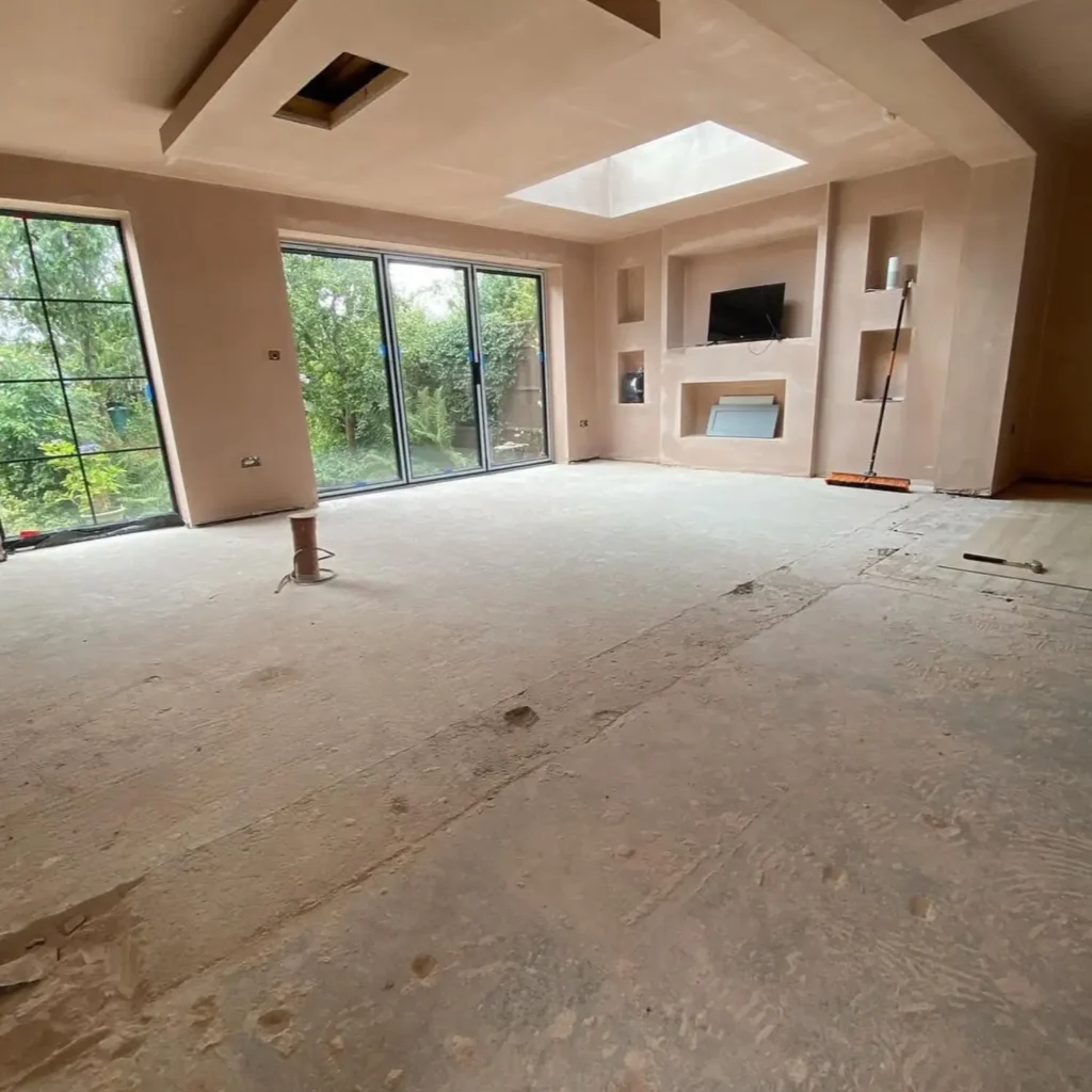 Flooring renovation before installation in Zurich living room, with bare subfloor and unfinished surfaces.