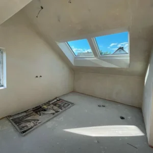 Bathroom renovation before works in Zurich apartment, with skylight and unfinished flooring.